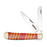 A collection of folding pocket knives with double blades and colorful resin handles, displayed on a stone surface.