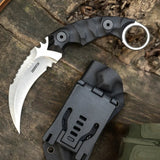 A black Karambit tactical knife with a curved blade and G10 handle, accompanied by a black Kydex sheath with a belt clip.