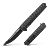 A black folding pocket knife with a stainless steel blade and textured handle, placed on a wooden surface.