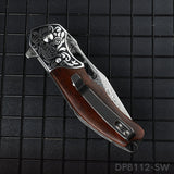 A folded pocket knife with a Damascus pattern blade and a dark rosewood handle, displayed on a dark textured surface.