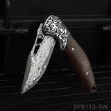 A folded pocket knife with a Damascus pattern blade and a dark rosewood handle, displayed on a dark textured surface.